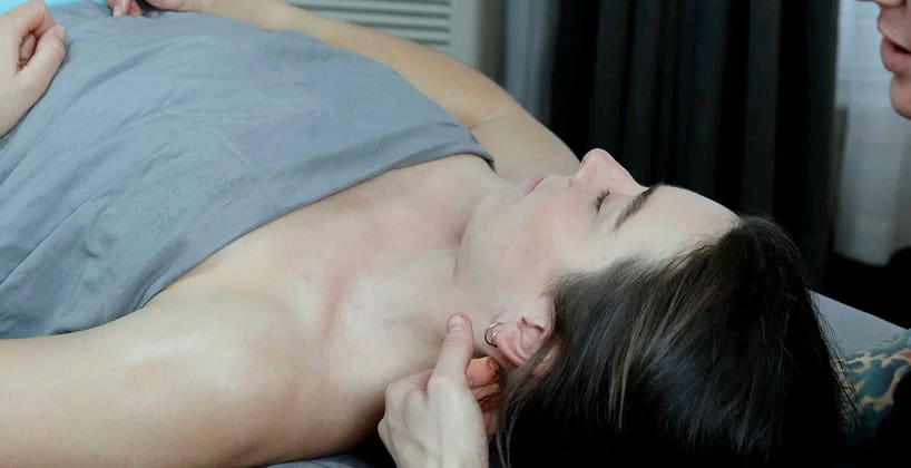 Person receiving neck and shoulder massage therapy.